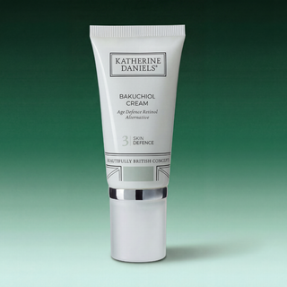 Katherine Daniels Bakuchiol Cream tube on a gradient green background